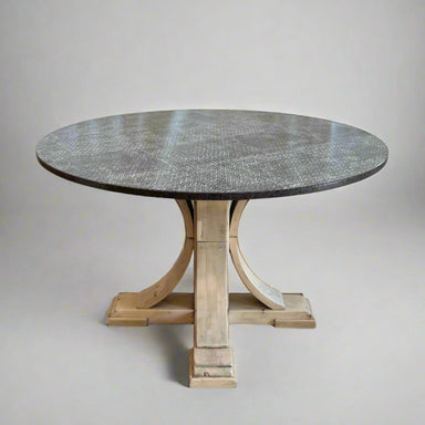 Round dining table with a stone top and wooden base on a plain background
