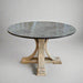 Round dining table with a stone top and wooden base on a plain background