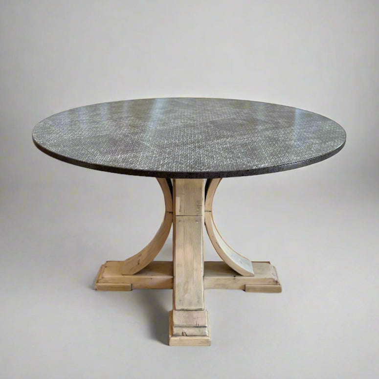 Round dining table with a stone top and wooden base on a plain background