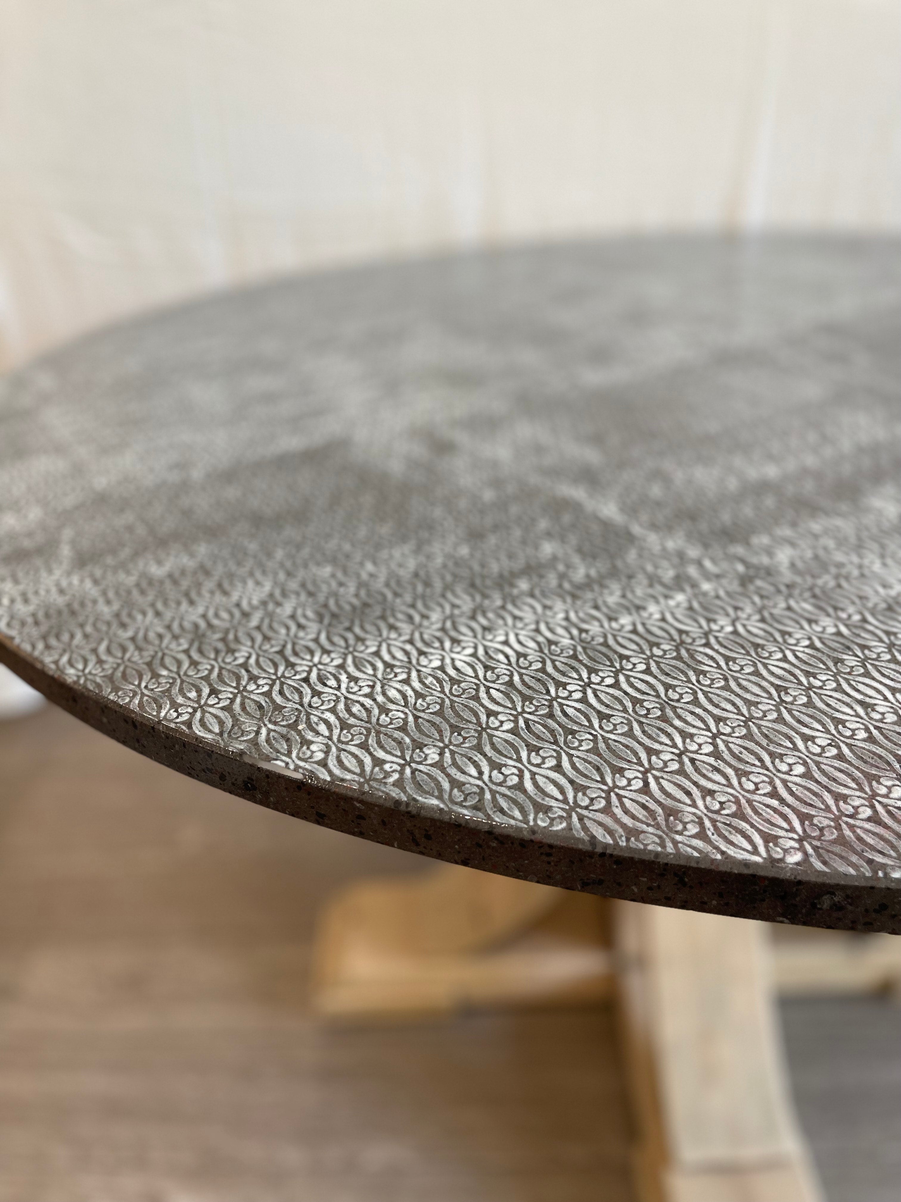 Round table with embossed design on a blurred background