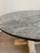 Round table with embossed design on a blurred background